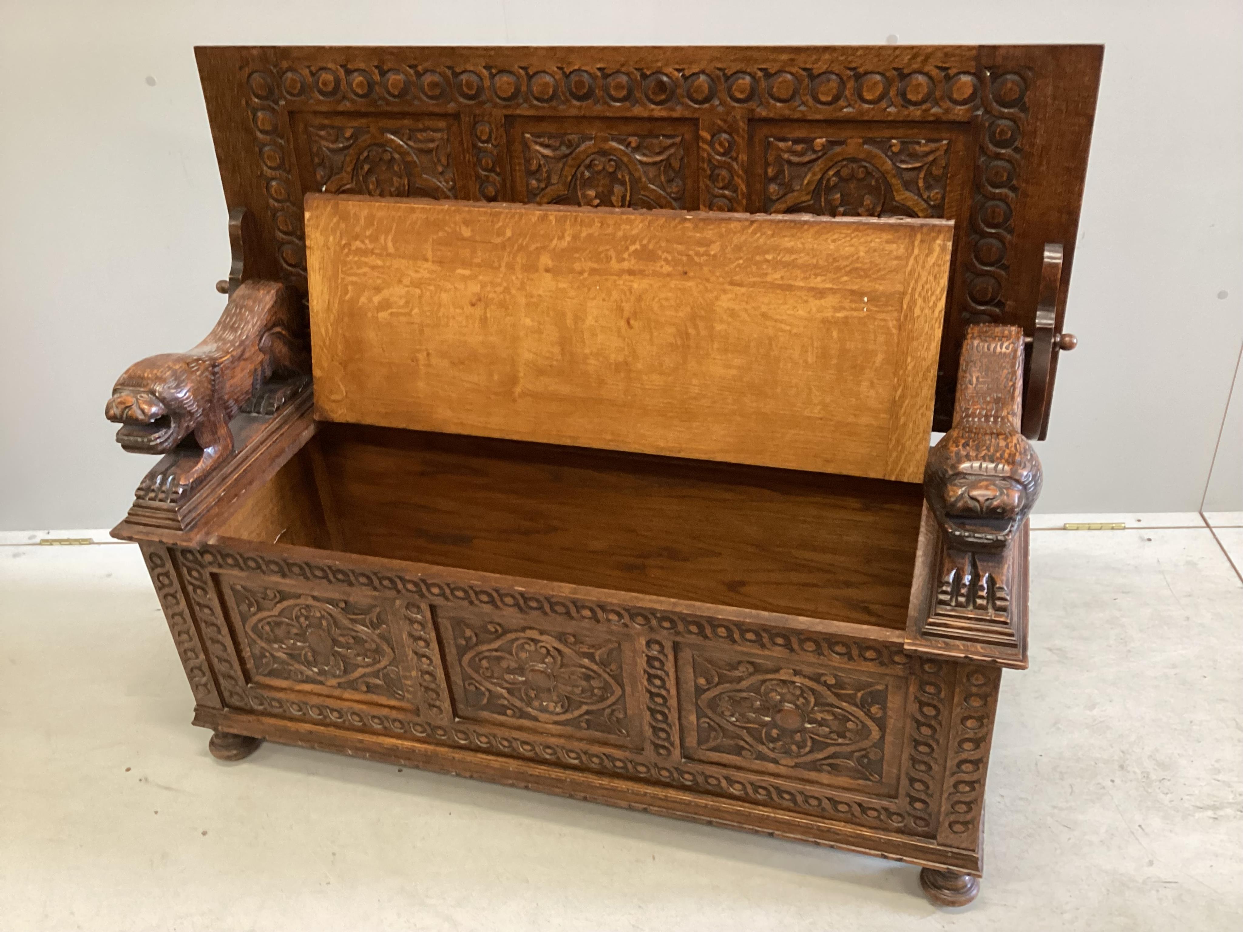 An early 20th century carved oak monk's bench, width 125cm, depth 49cm, height 98cm. Condition - good